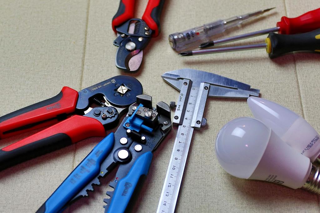 Technician performing electrical emergency repair outdoors