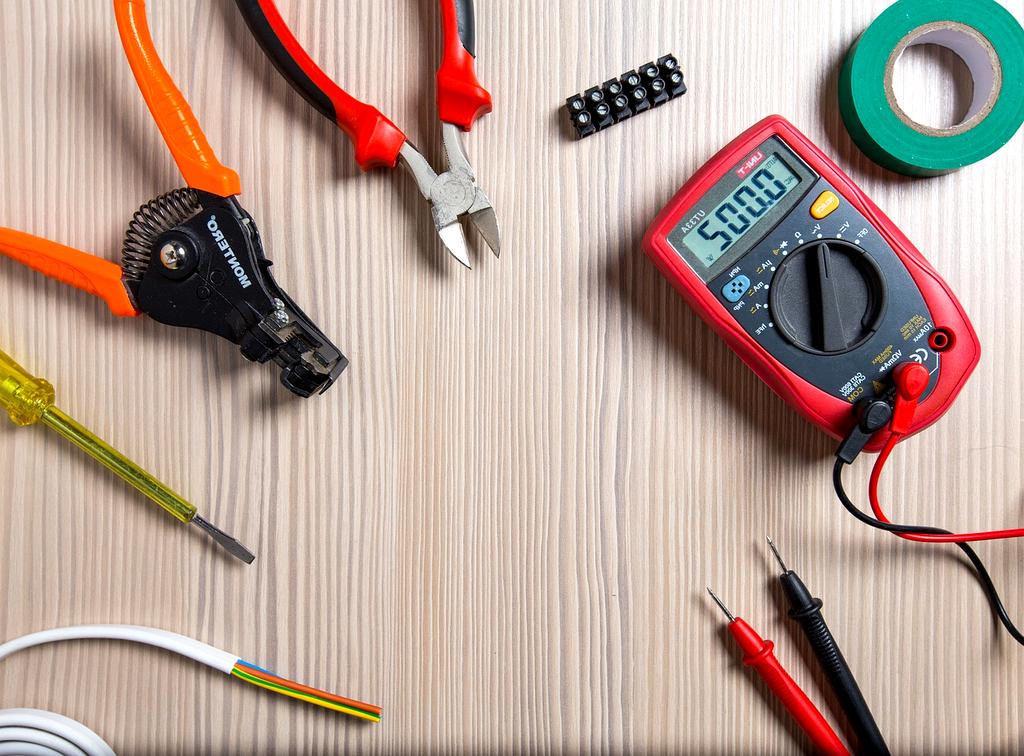 Electrician working on electrical wiring in a modern Singapore building